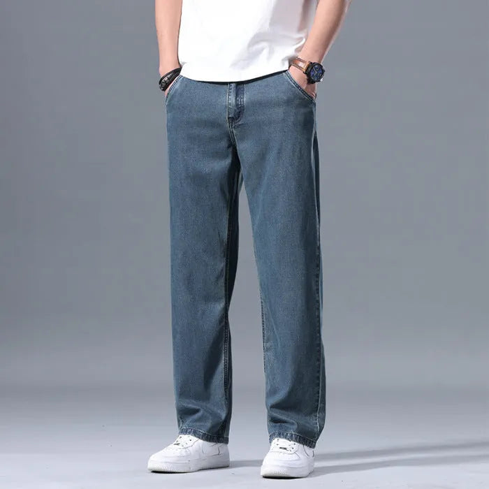 Men's light blue loose straight-leg lyocell jeans laid flat showing zip fly and relaxed fit