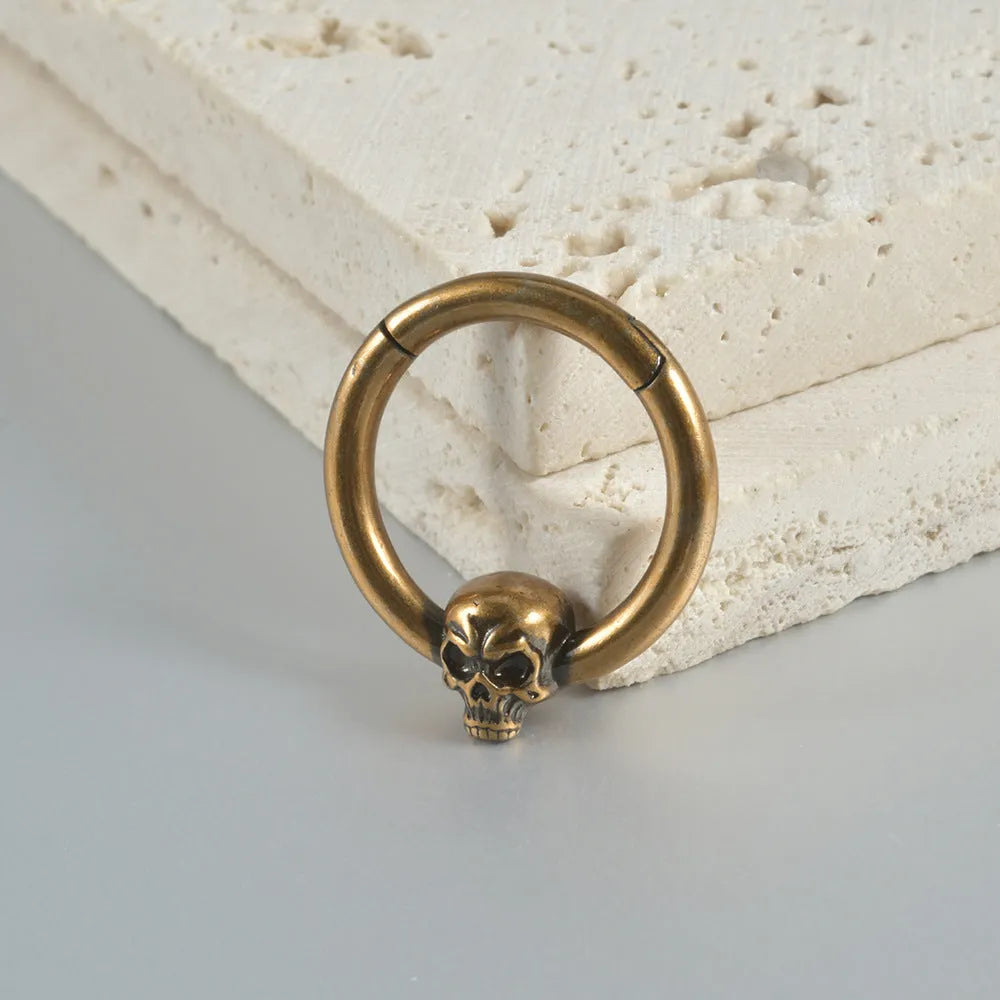 Copper punk earrings with vintage ghost head designs in antique gold and silver metallic finishes