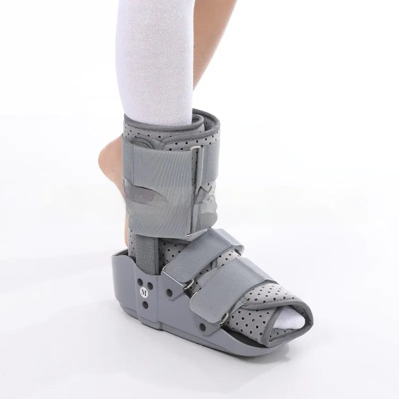 Achilles tendon rehabilitation walking boot in grey colour with adjustable strapping and rocker sole