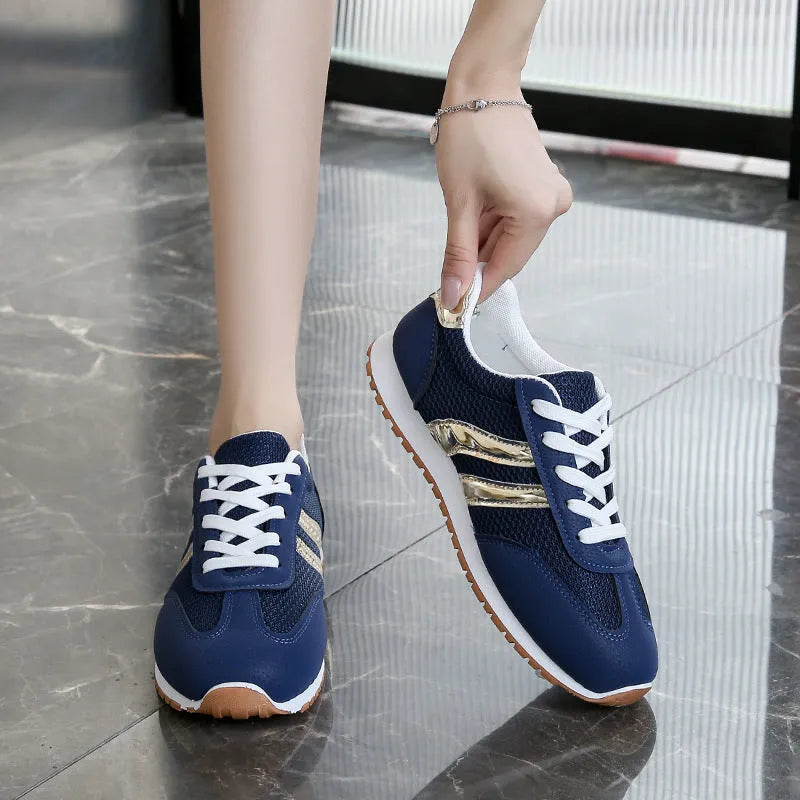 Blue women's sports shoes with cross shoulder straps, round toe, and flat rubber sole.