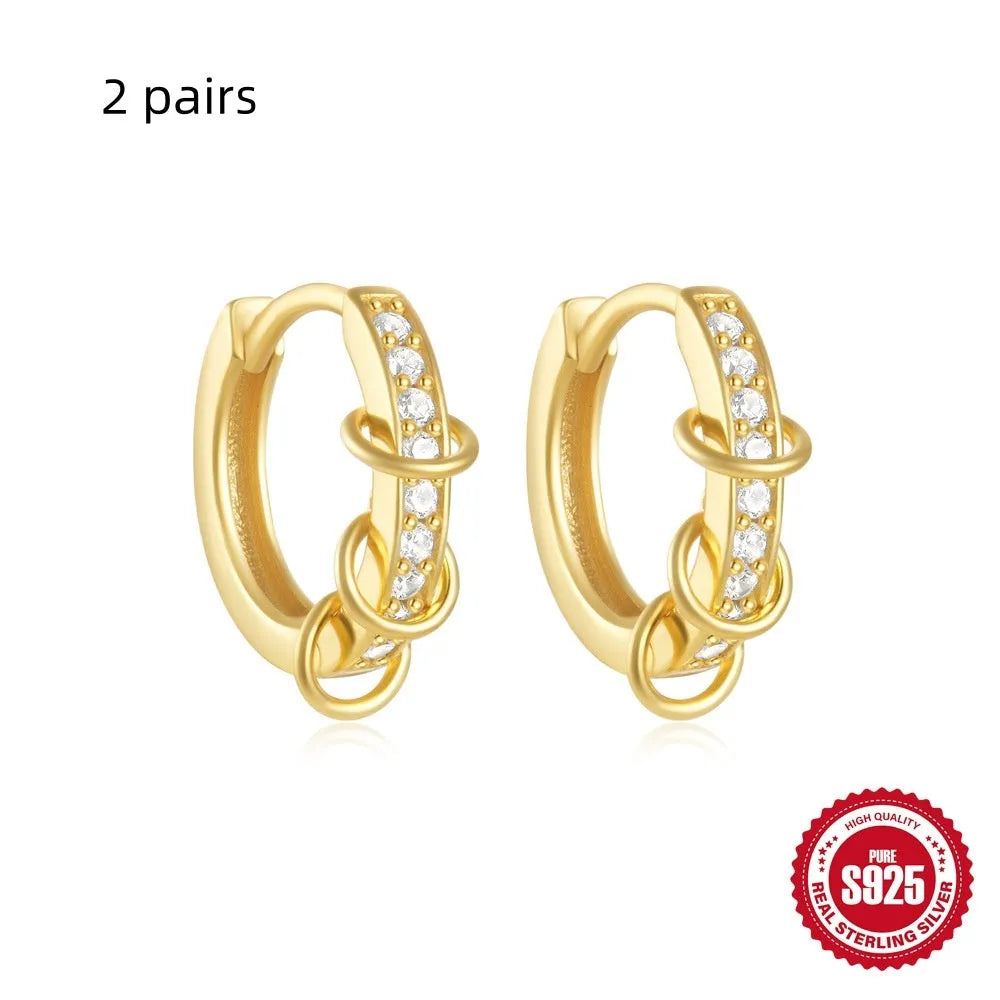 Sterling silver geometric stud earrings with round diamond accents in gold and silver electroplated finishes