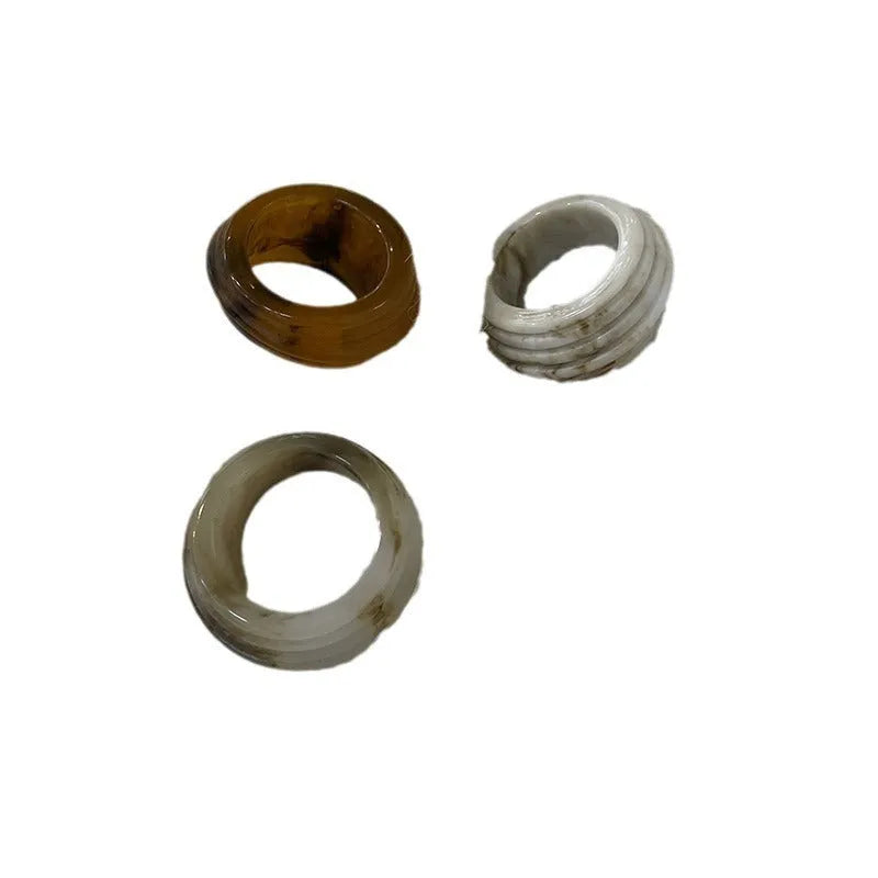 Chinese style irregular geometric resin wide ring in neutral colours on display