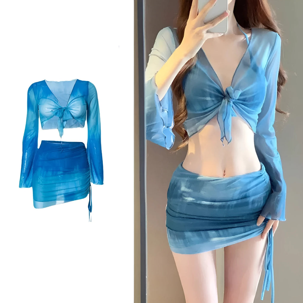 Women's blue four-piece bikini swimsuit set with high-waisted briefs, shirt, and skirt laid flat.