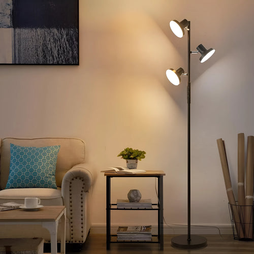 Black adjustable floor lamp with rotatable head and remote control in a living room