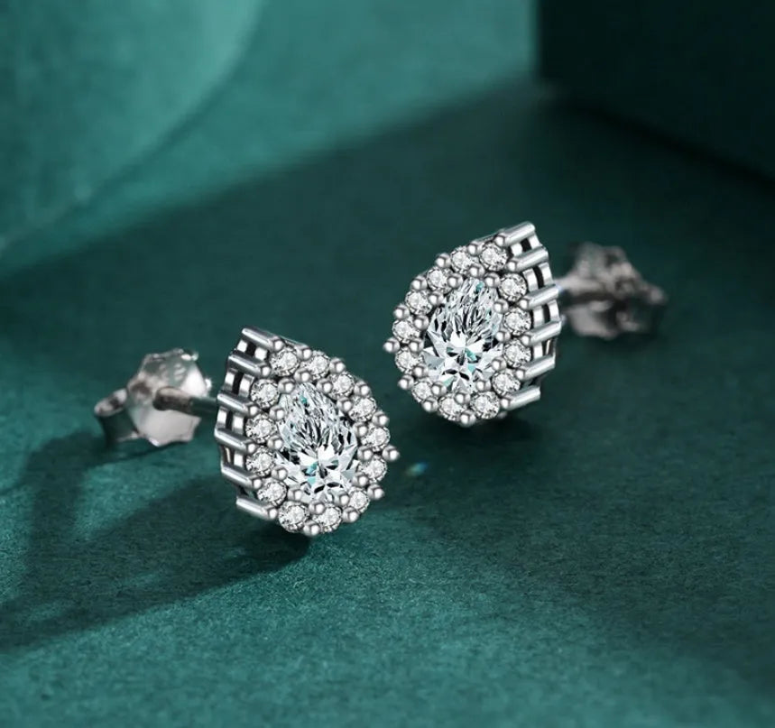 A pair of silver drop shape ear studs for women with a diamond-treated finish.