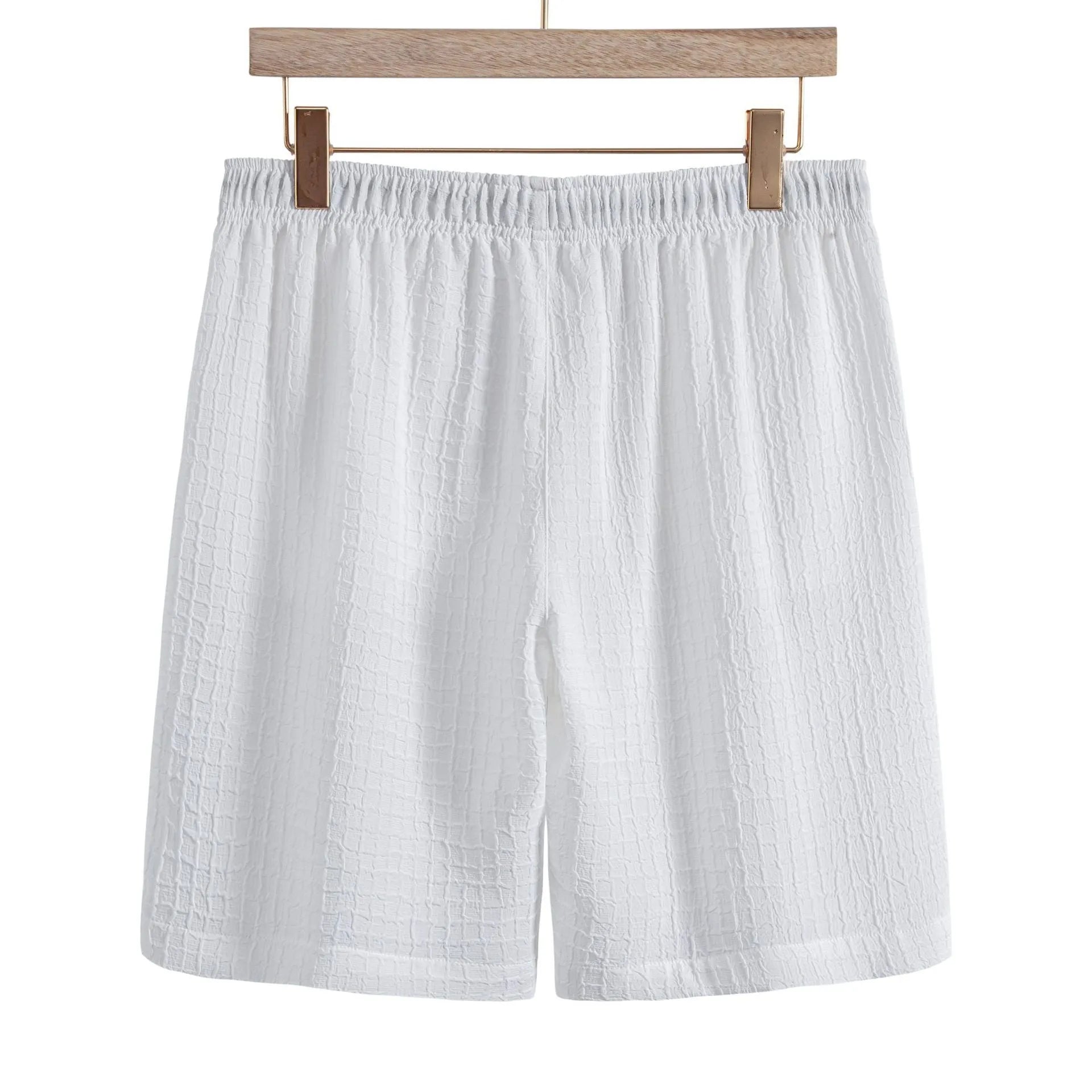 Men's white jacquard cotton blend short sleeve shirt and matching shorts laid flat.