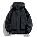Man wearing a black hooded waterproof windproof jacket with long sleeves.