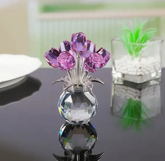 Geometric crystal glass rose ornament in red colour on wooden surface
