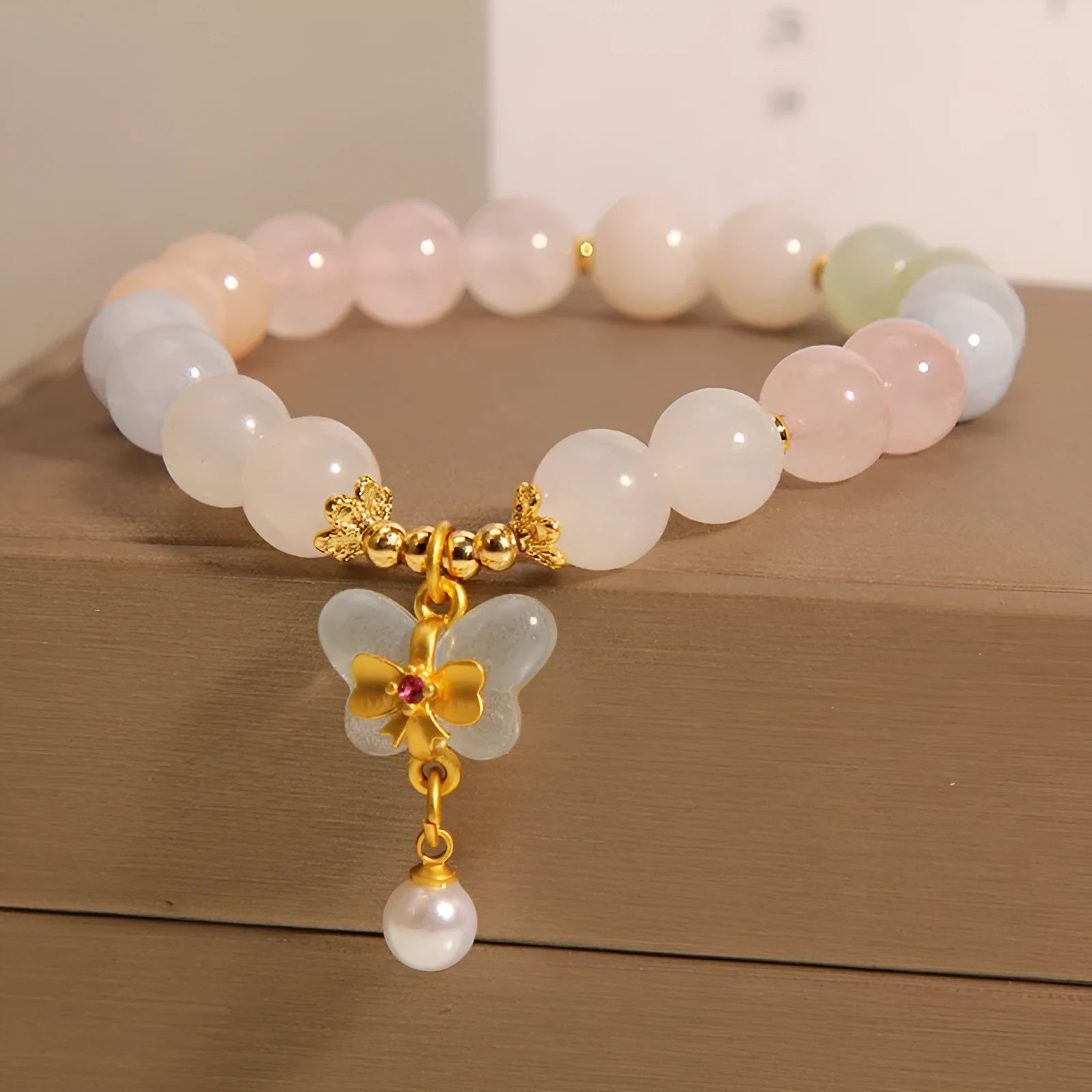 Women's colourful Morgan stone butterfly pendant crystal bracelet on wrist.