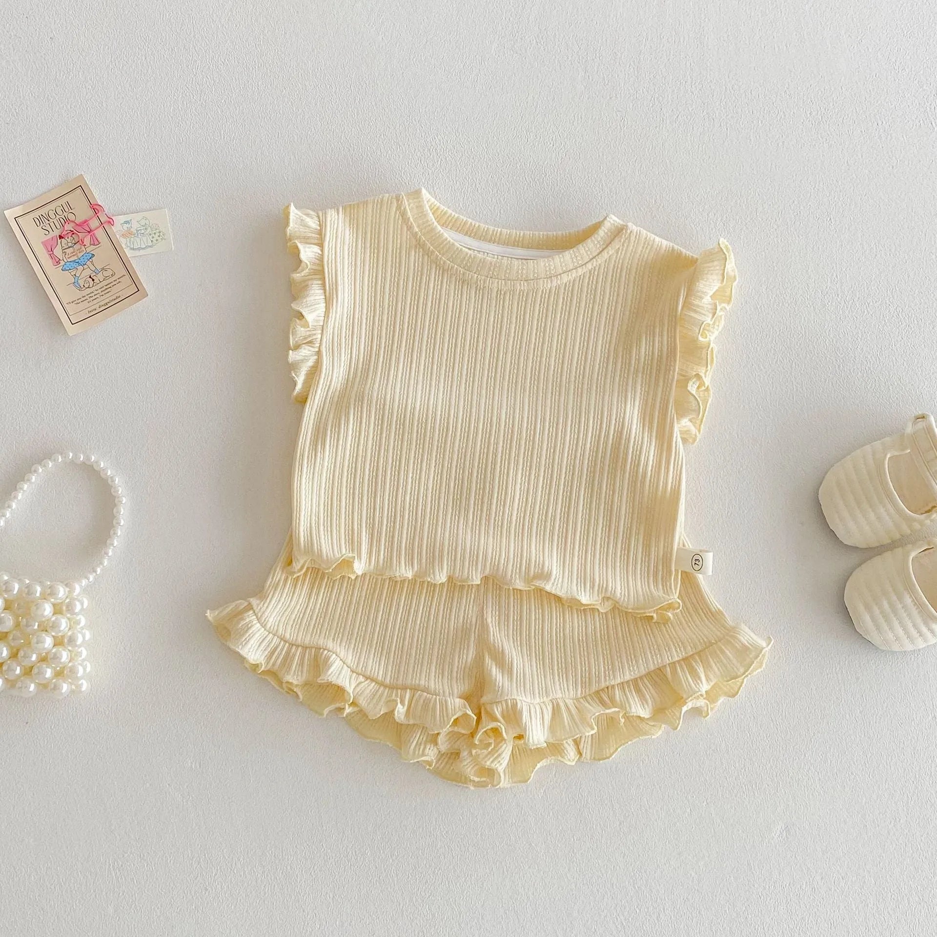 Baby girl two-piece cotton shorts set in light beige with wooden ear vest top and matching shorts