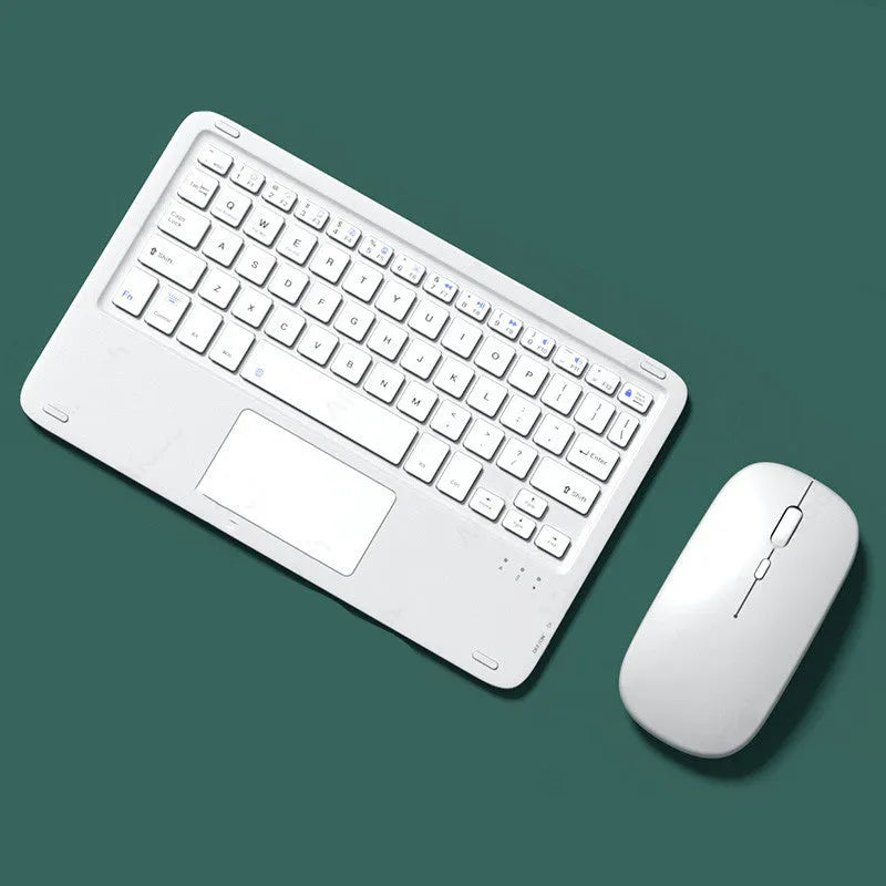 Pink Bluetooth touch keyboard and rechargeable wireless mouse on a desk next to a tablet.