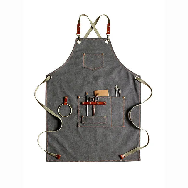 Canvas apron with cross-back straps in camel colour for cafe or baking work