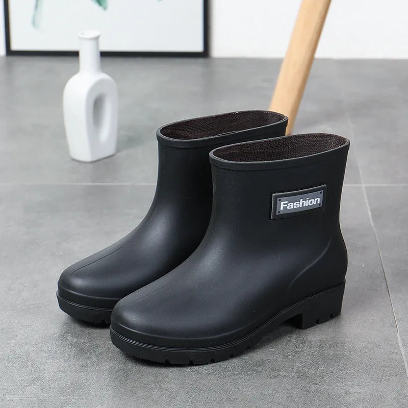 Women's mid-calf PVC rain boots in black with low heel design