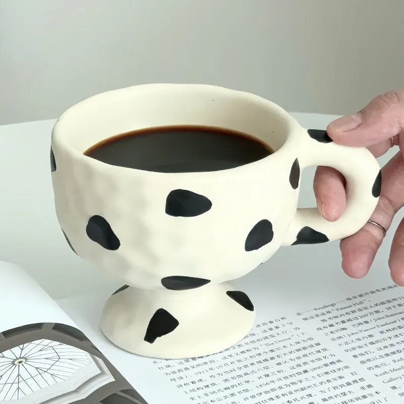 Hand-pinched irregular ceramic mug in solid colour with modern design