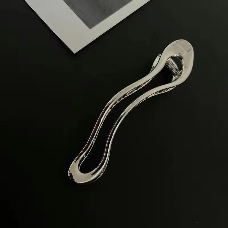 Gold and silver zinc alloy hair clip barrettes in arc, square, and triangle shapes.