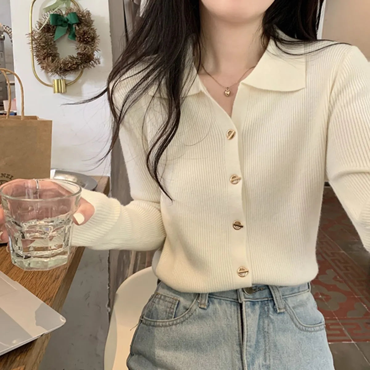 Loose fit knitted cardigan in beige, shown worn open as a long-sleeved top