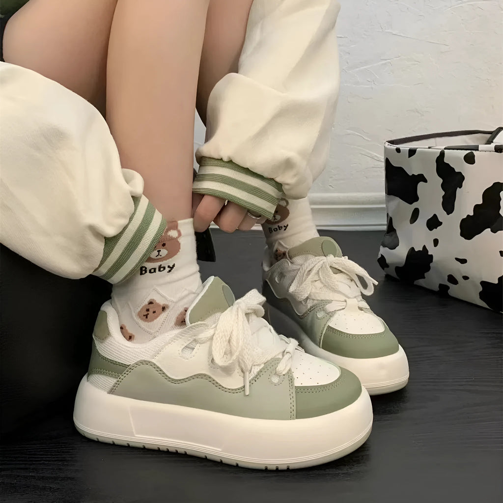 Green women's casual shoes with mesh upper, round toe, and flat non-slip sole.