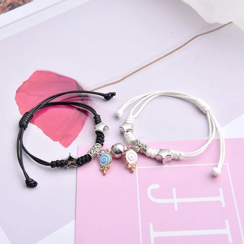Magnetic clasp couple bracelets with alloy construction and symbolic designs including crown and love lock motifs.