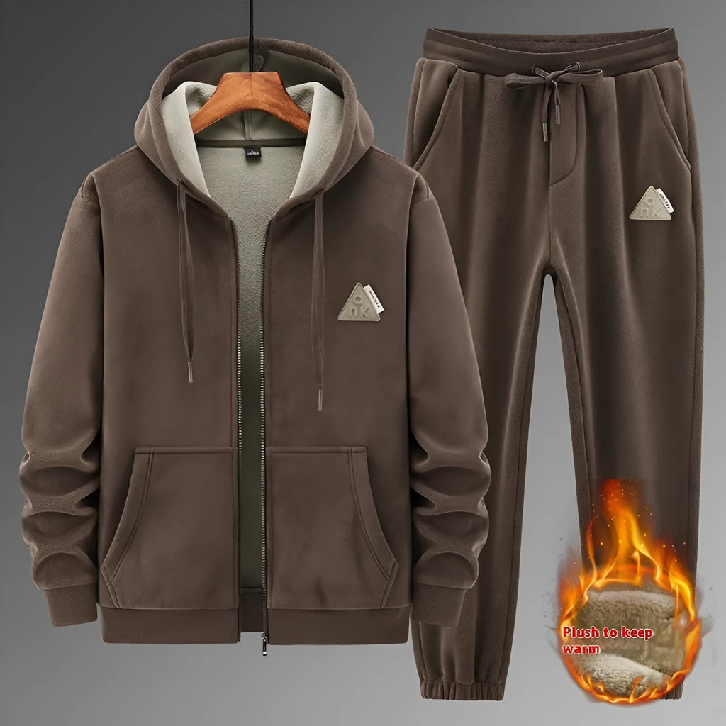 Grey hooded sweater and matching trousers casual sports suit on a hanger.