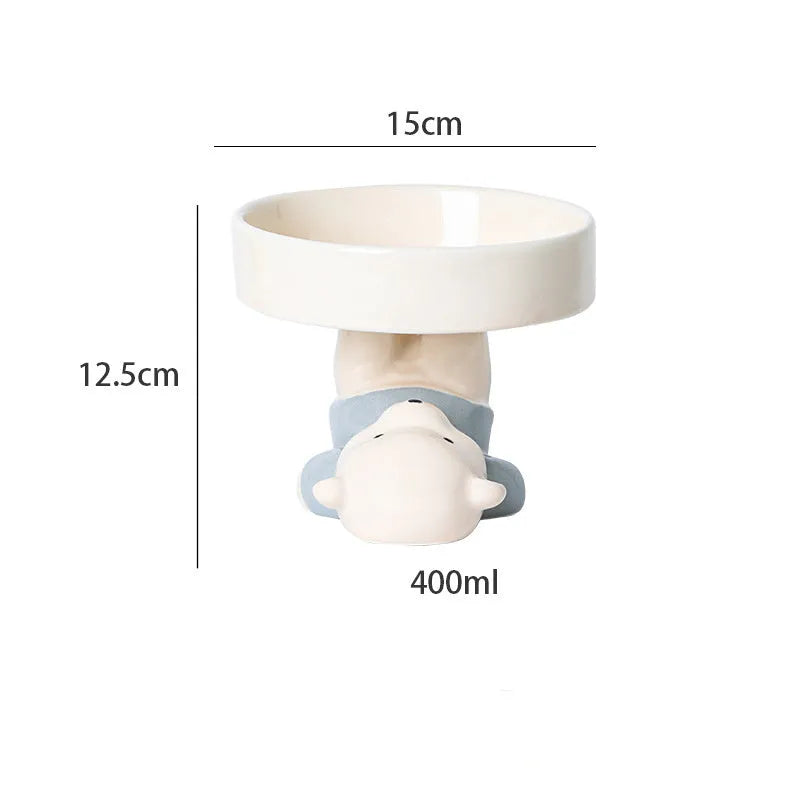 Ceramic raised cat bowl in animal theme design on a floor