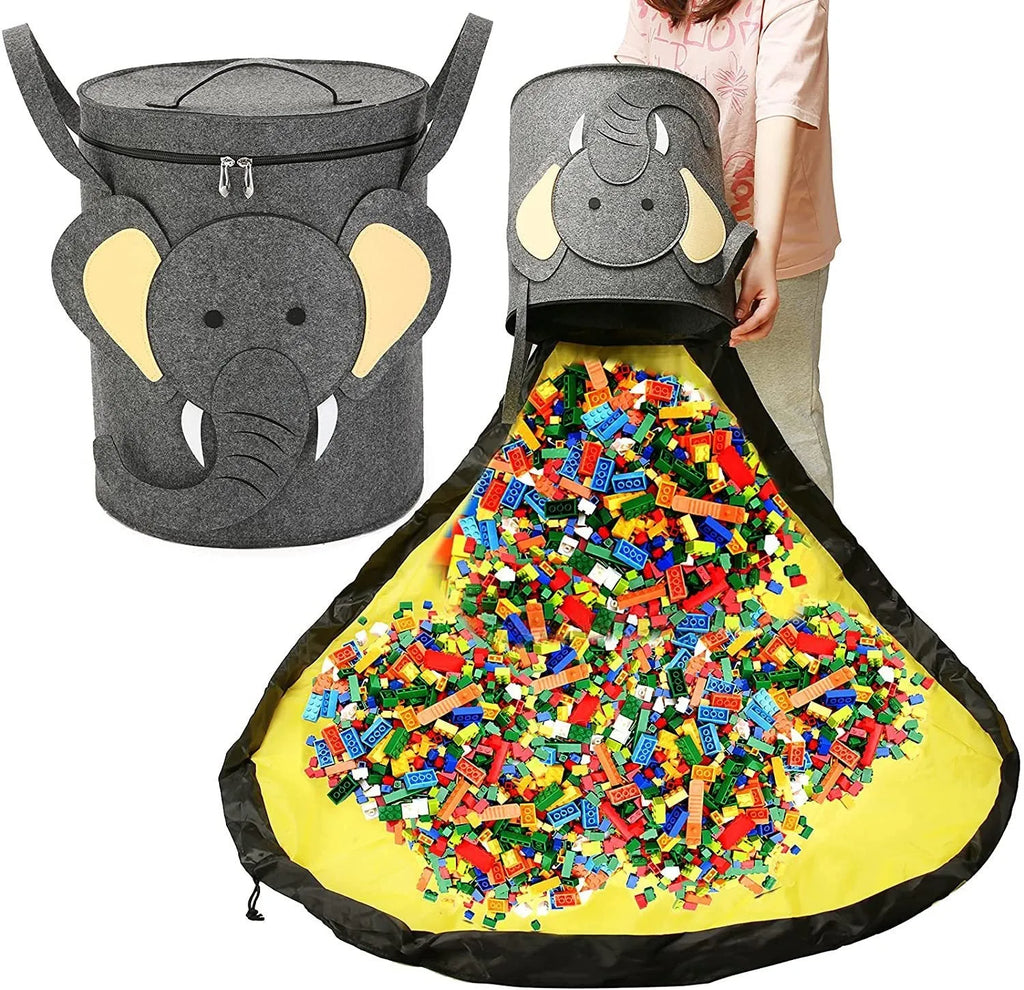 Green felt cube storage bag with pull rope, laid flat as a play mat for toys.