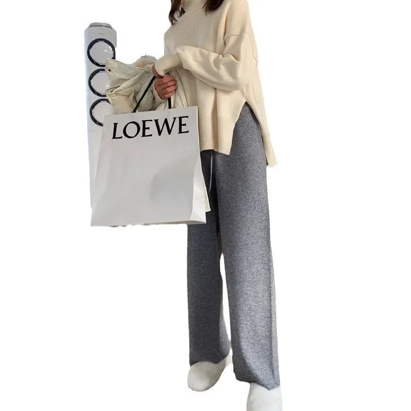 Women's high-waist knitted wide-leg trousers in a cream white colour, showcasing the straight-leg mopping style.