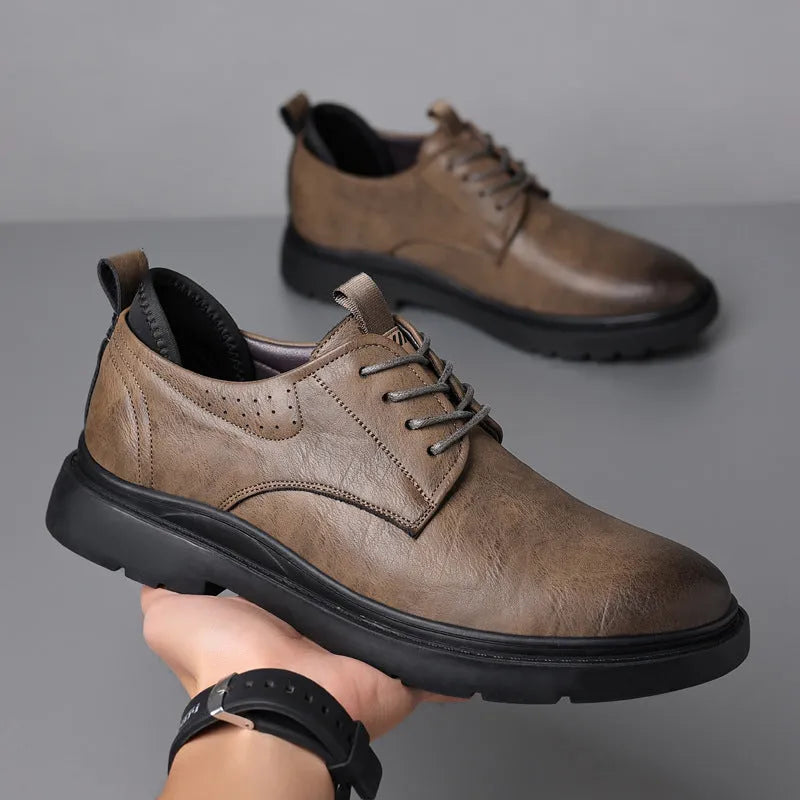 Men's black and brown leather sneakers with rubber sole and decorative sewing line detailing on cowhide upper