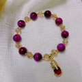 Handmade Vanves Stone Tigereye bracelet on wrist, showing single and double chain options with fox and leather charms.