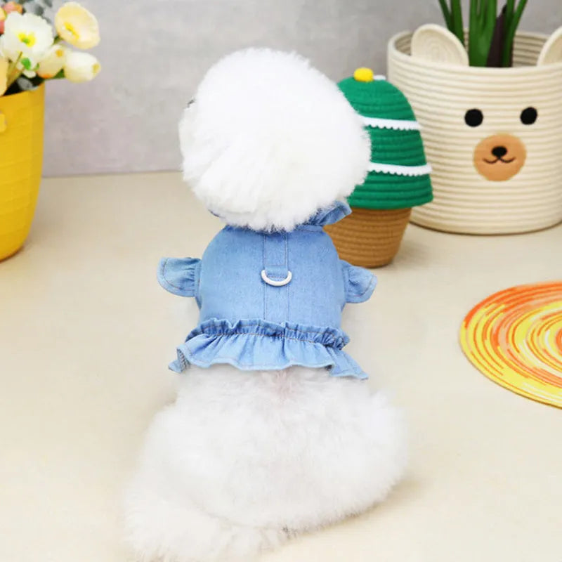 Blue denim dog dress with chest ruffles and a leash hook on the back, shown in dark blue and light blue.