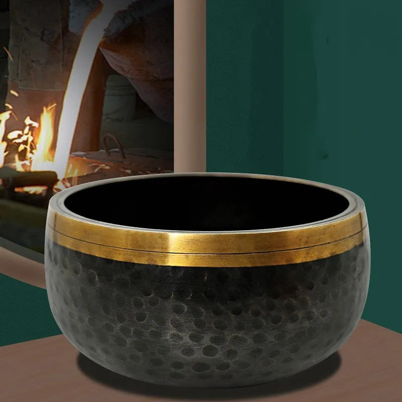 Black and gold copper sound bowl with Buddha design on thin pad, 12.5cm calibre