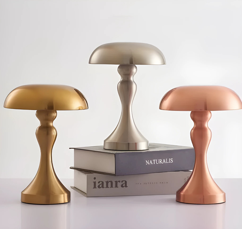 Metallic-finish USB charging desk lamp with touch control on a wooden desk.