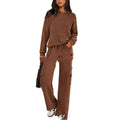 Women's black polyester leisure sports suit set with long sleeves and trousers laid flat.