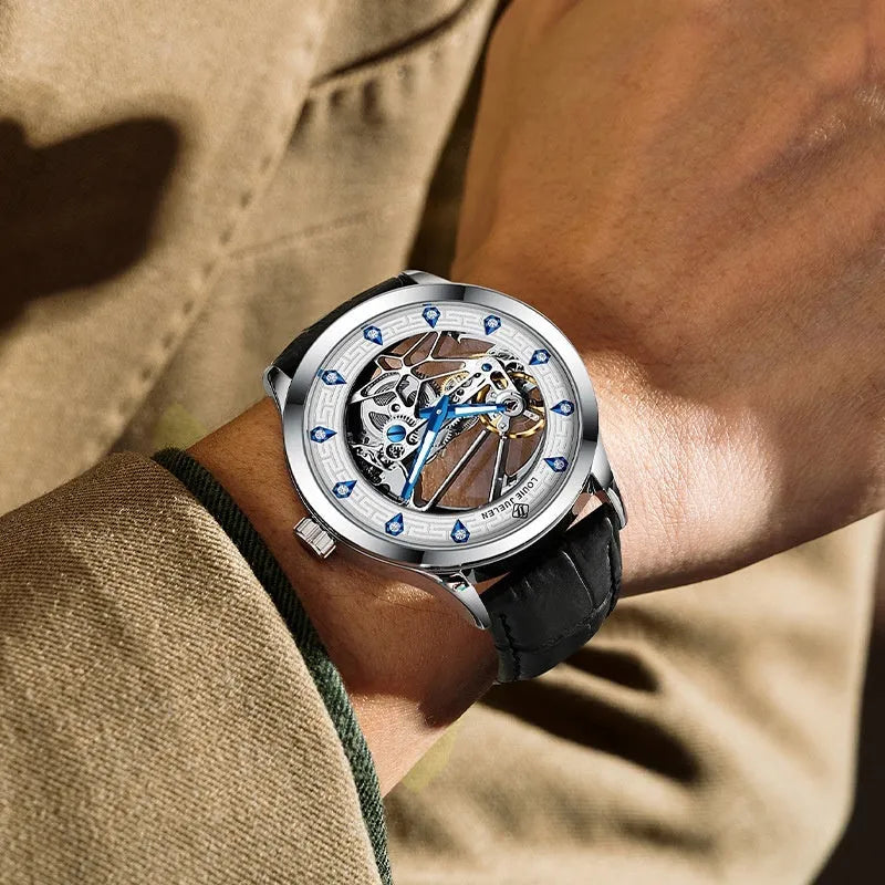 Men's silver mechanical watch with white dial, blue hands, black leather strap, and stainless steel butterfly buckle
