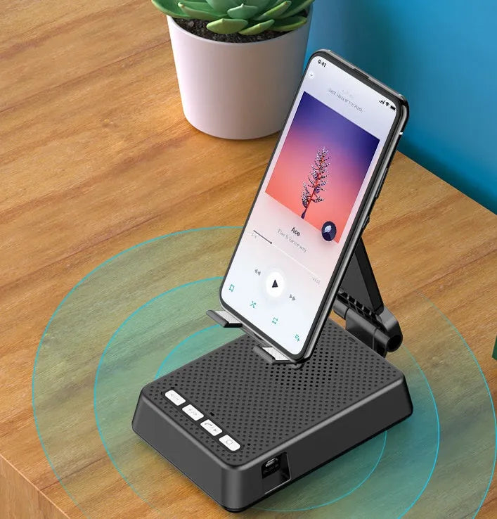Black mobile phone broadcasting stand with integrated Bluetooth speaker and microphone on desk