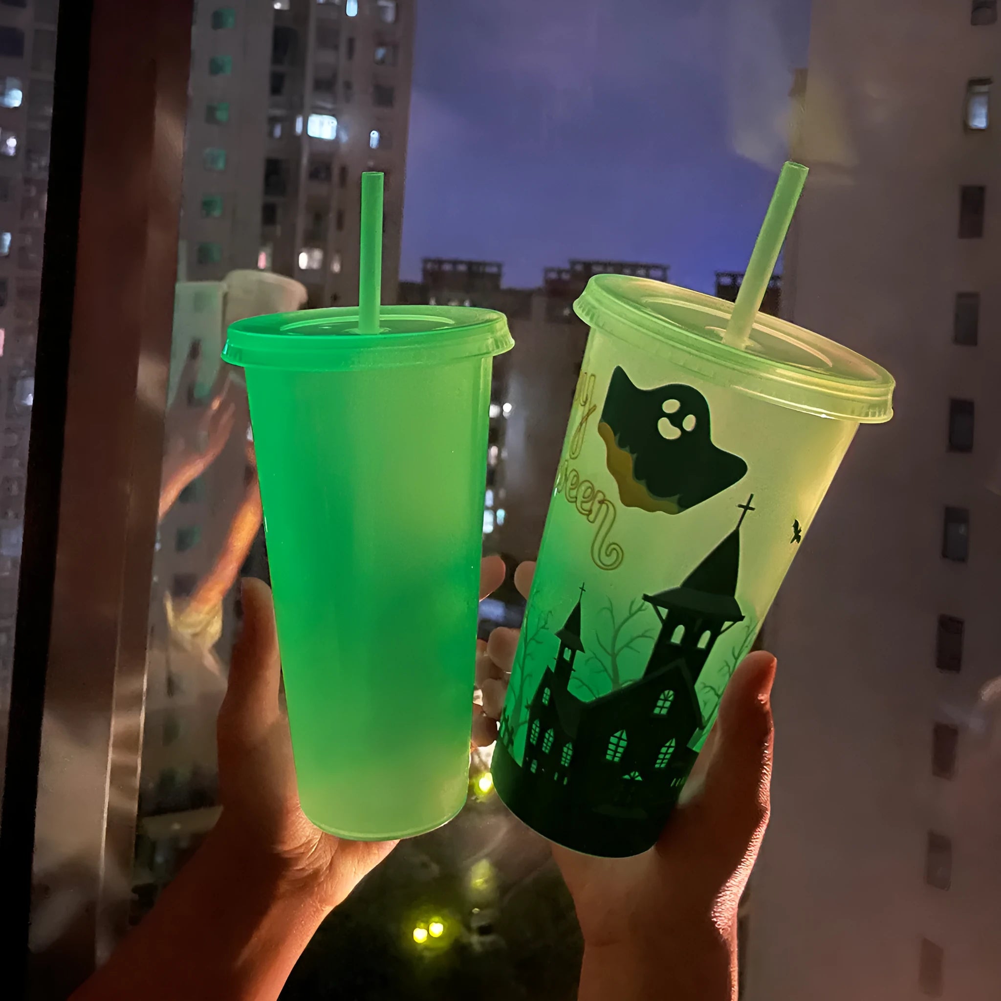 A 720ml cylindrical plastic cup with a luminous straw, shown in various colours for Halloween.