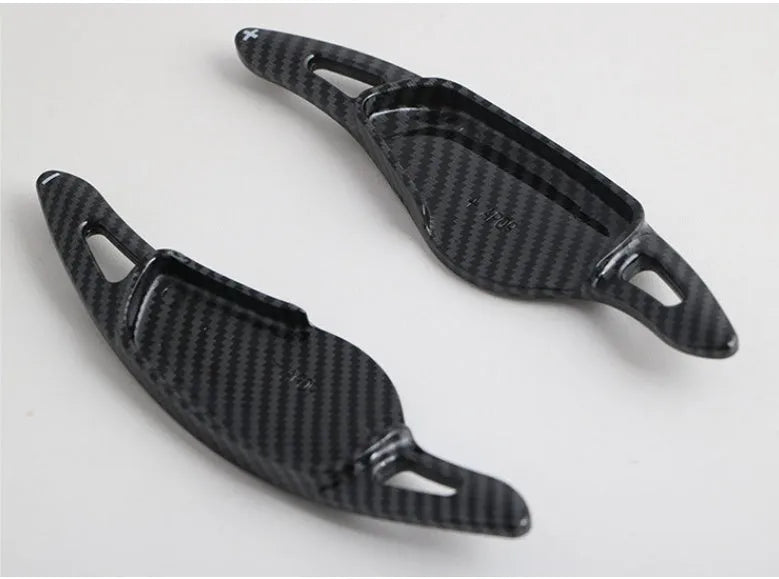 Carbon fibre pattern steering wheel paddle shifters in black and red finishes
