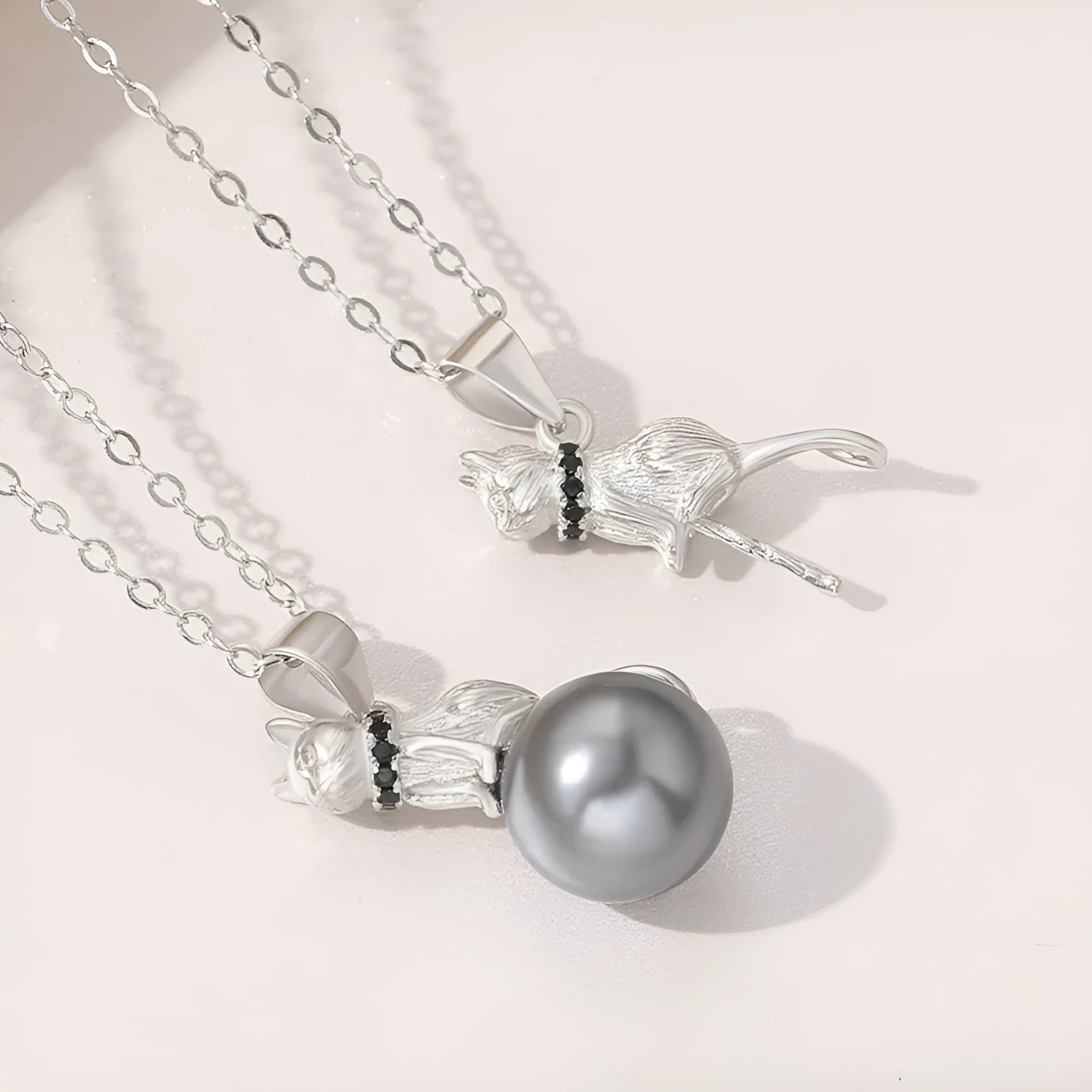 925 sterling silver cat pendant necklace on a chain, elegant style, shown in two colour finishes.
