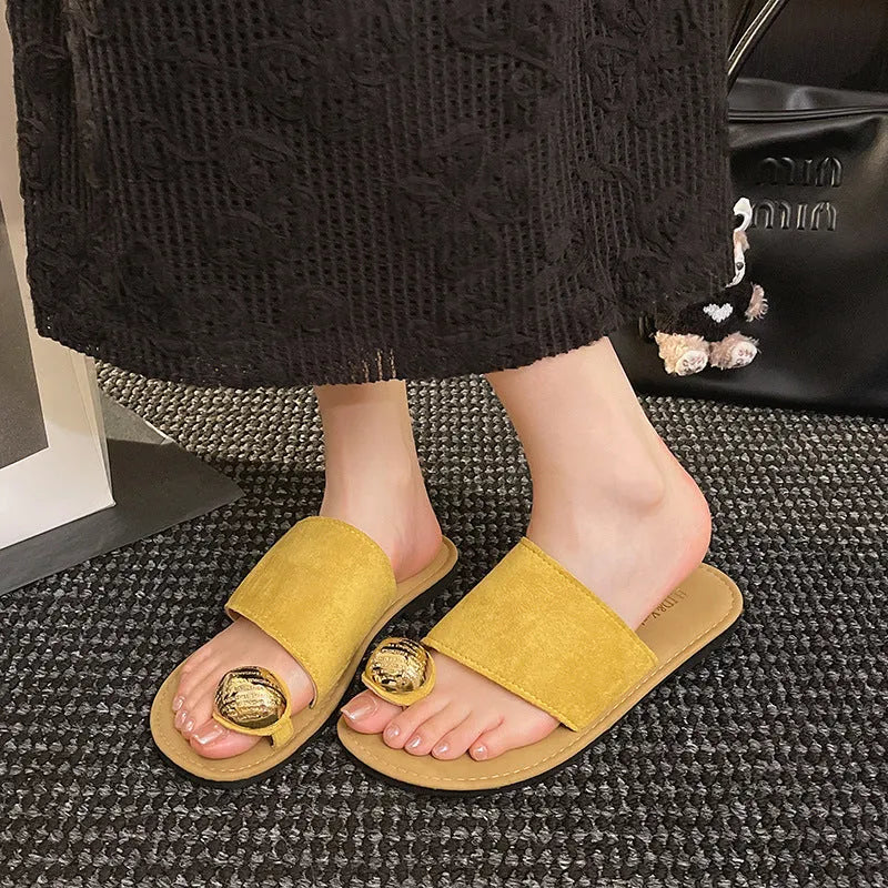 Women's flat bottomed French toe flip flops in solid colours on a light background