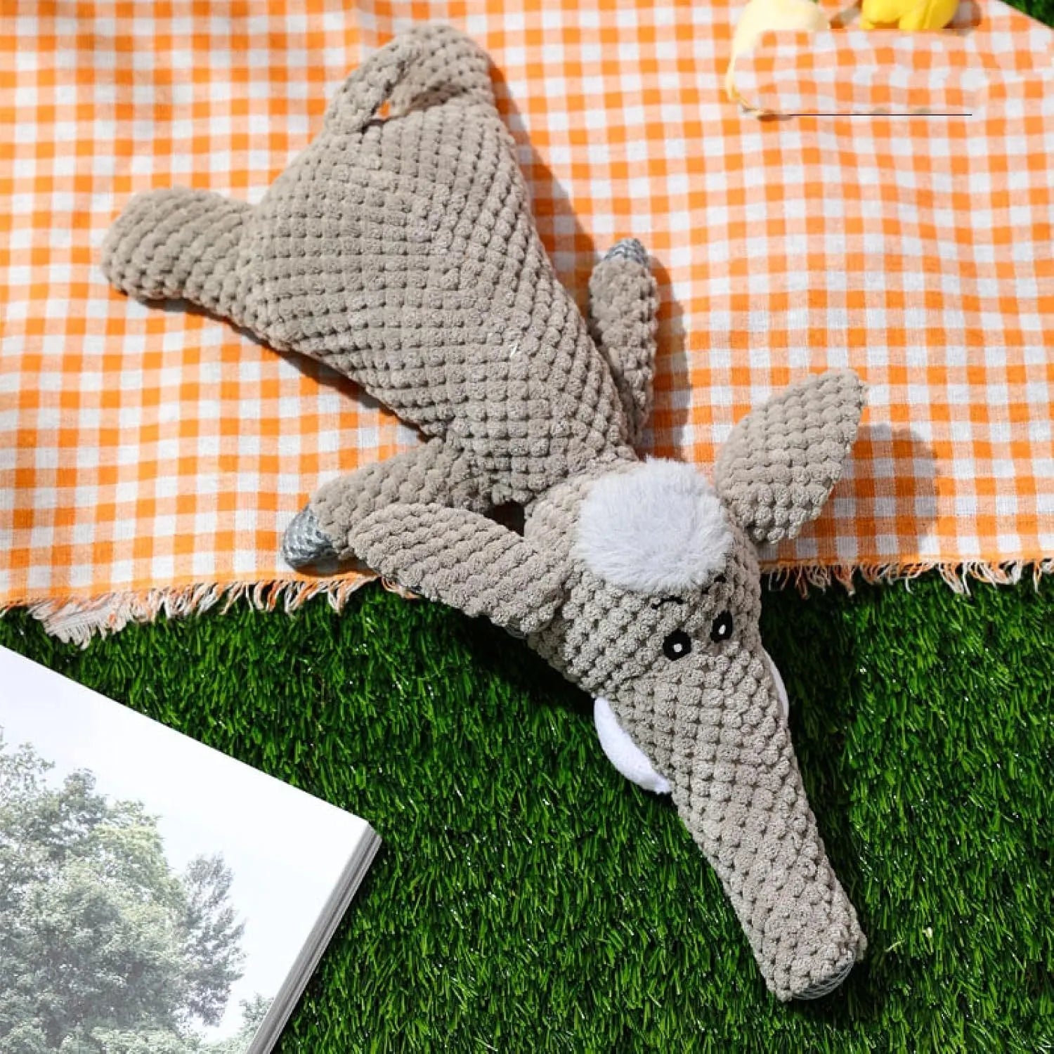 Colourful plush dog toy in animal shape with corn kernel texture and squeaker.