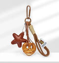 Handmade soda bread handbag pendant ornament with brown carrying strap on a bag.