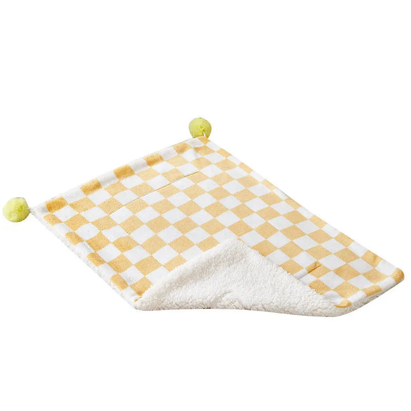 Green plaid pattern plush pet blanket for cats and dogs on a sofa