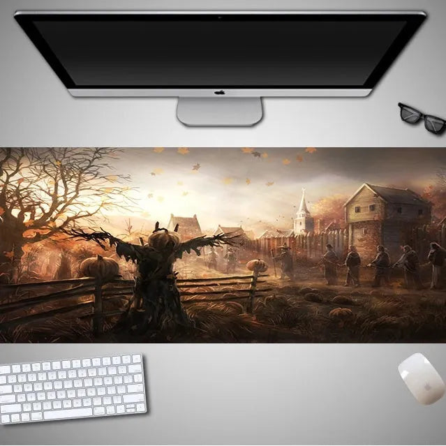 Oversized Halloween graphic cloth mouse pad on a desk, showing non-slip rubber base.