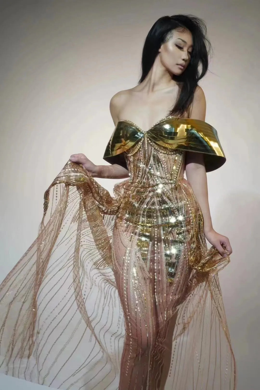 Gold sequined strapless long dress with a tulle skirt and high side slit.