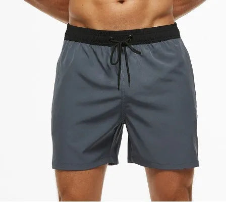 Men's blue running shorts with a stitching waistband, drawstring, and a side zippered pocket.
