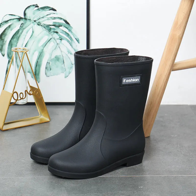 Women's mid-calf PVC rain boots in black with low heel design