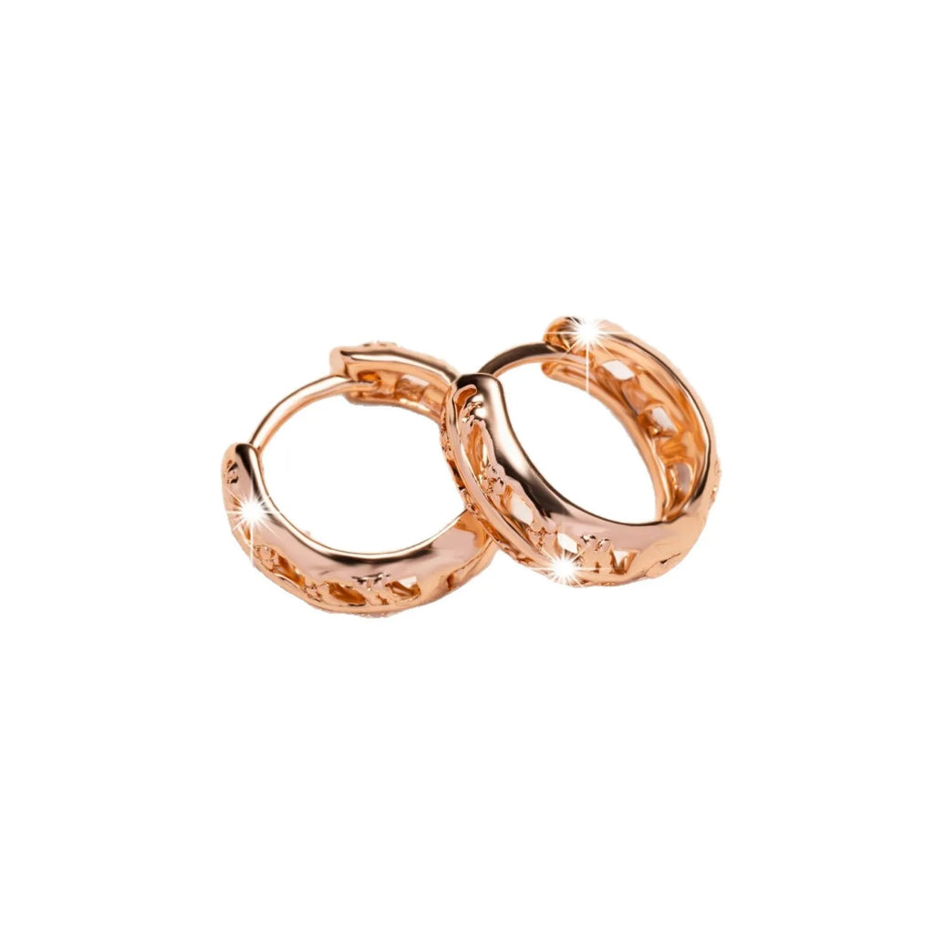 Rose gold hollowed copper earrings in leaf and heart shapes on a white background