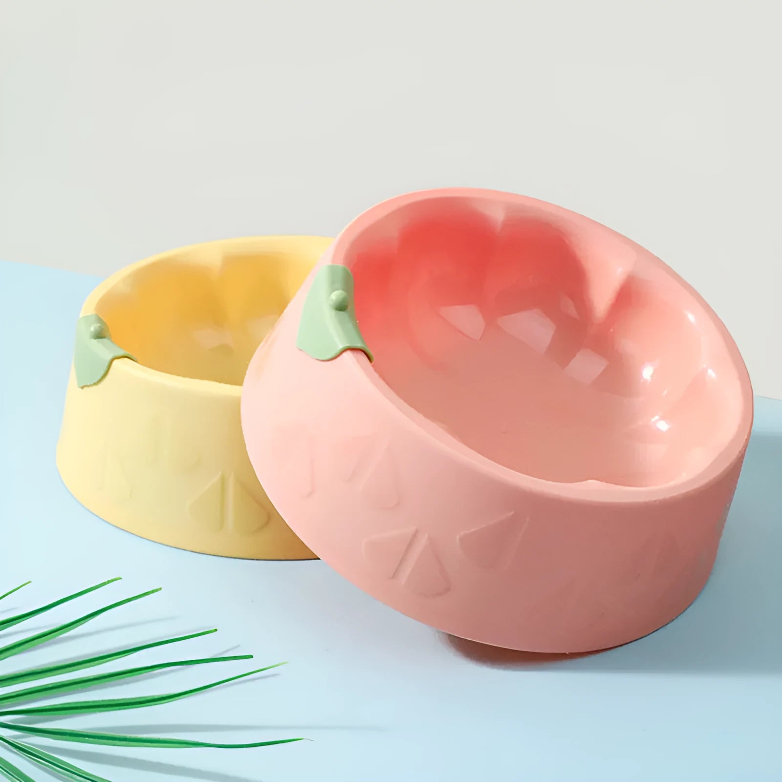 Green plastic double pet bowl feeder for dogs and cats on a white background