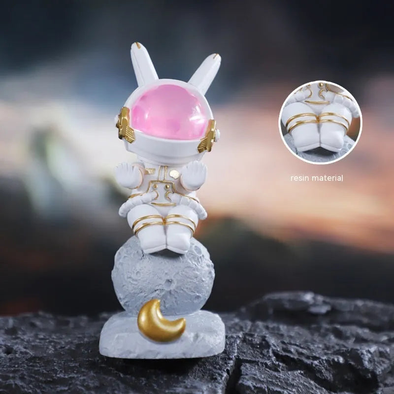 Space rabbit resin mobile phone stand in pink for desktop use