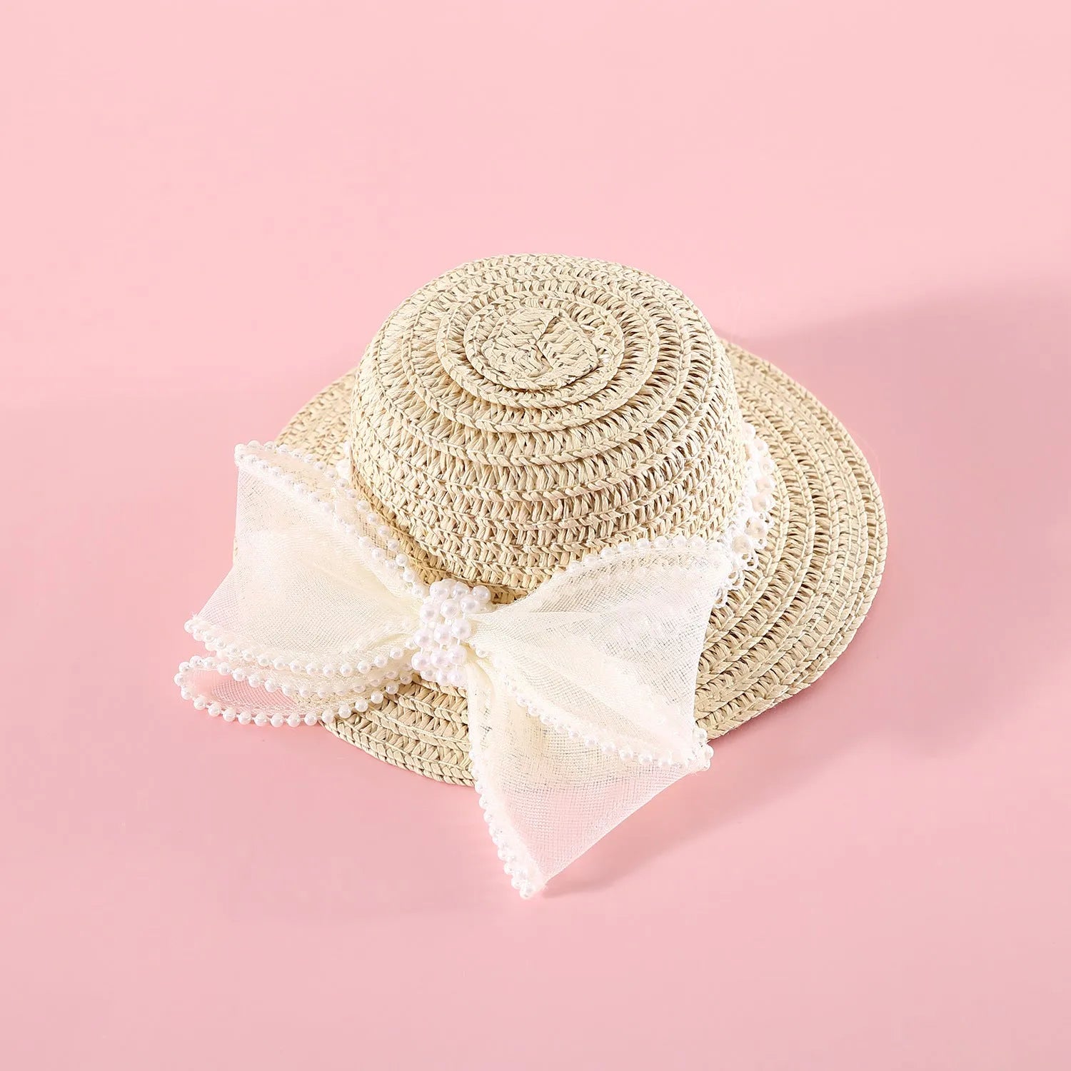 Woven straw hat for a cat with a large central pearl bow, available in blue, pink, purple, and white.