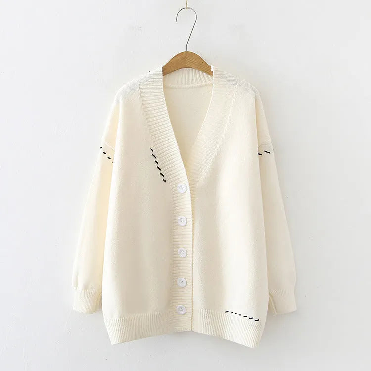 Women's knitted cardigan top coat in black or white with loose fit and long sleeves